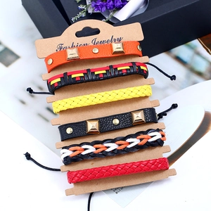 Detailed view of six vintage braided leather bracelets on a fashion jewelry display card
