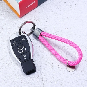 Pink braided leather car keychain with dark grey metal ring and round tag detail