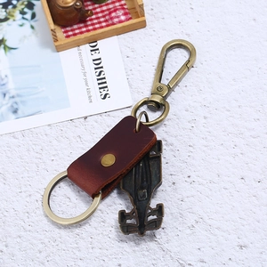 Vintage leather keychain with bronze racing car pendant and durable metal clasp