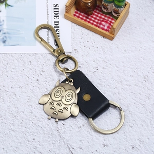 Retro bronze owl keychain with detailed feather texture and black leather strap for keys