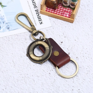 Vintage bronze alloy keychain with dark brown leather strap and rotary carabiner hook