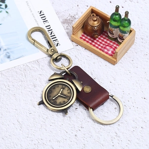 Vintage bronze alarm clock keychain with dark brown leather strap and sturdy metal hook