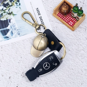 Vintage bronze baseball hat pendant on black leather strap keychain with lobster clasp