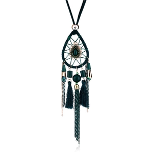 Detailed view of bohemian dreamcatcher necklace with dark green teardrop stone and tassels