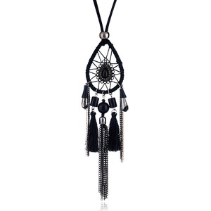 Detail of bohemian dreamcatcher necklace featuring black beadwork and silk tassels