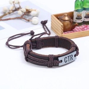 Retro deep brown braided leather bracelet with CTR silver metal plate shown at 45-degree angle