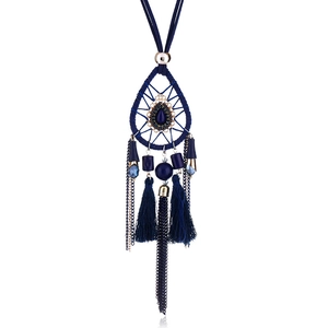 Detail of bohemian dreamcatcher necklace with dark blue beads and tassels