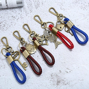 Vintage bronze woven leather keychain set featuring heart and owl pendants for couples