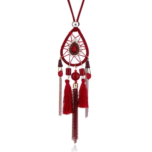 Detailed view of red bohemian dreamcatcher necklace with bead fringe and fabric tassels