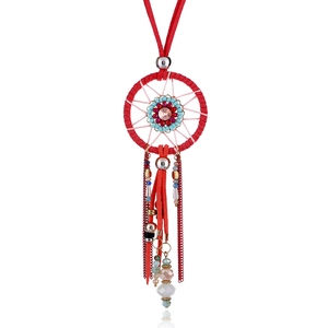 Detail of red dreamcatcher pendant necklace with turquoise beads and suede fringe