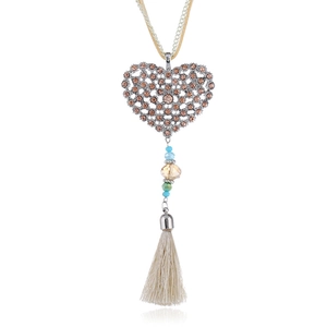 Close-up of heart pendant with rhinestones, colorful beads and silk tassel detail