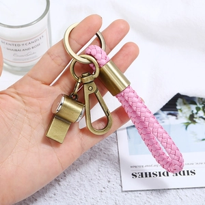 Pink braided leather keychain with vintage bronze whistle pendant and clasp