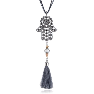 Detail of silver Hamsa Hand pendant with grey rhinestones and long silk tassel