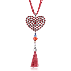 Detailed view of silver heart pendant with red rhinestones and colorful beaded silk tassels