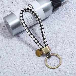 Braided black and white leather keychain with vintage gold metal ring and hardware
