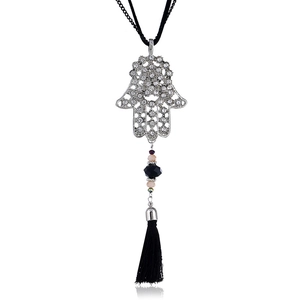 Detail of Hamsa Hand pendant with sparkling rhinestones and black tassel on long necklace
