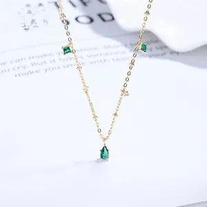 Close-up of a 925 silver necklace with green pear-cut and square-cut zircon stones