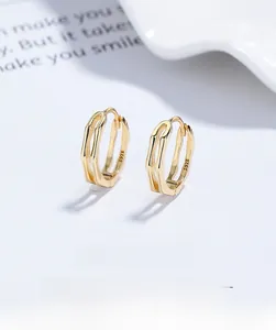 Detailed macro view of S925 sterling silver bamboo joint hoop earrings in gold finish