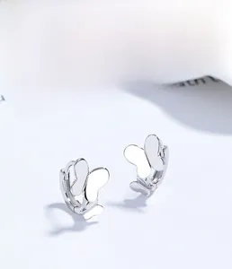 Macro detail of S925 sterling silver butterfly hoop earrings with polished finish