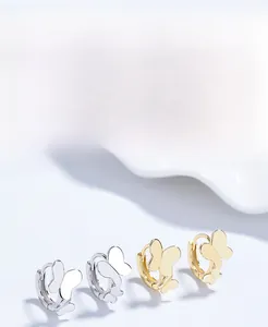 Detail of S925 sterling silver butterfly hoop earrings in polished gold and silver finish