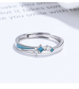 Macro shot of S925 sterling silver ring featuring blue enamel and sparkling zircons