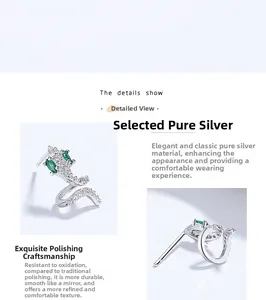 Detailed macro view of S925 sterling silver snake earrings with emerald green crystals
