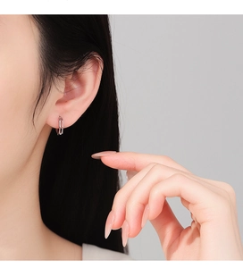 Detailed close-up of S925 sterling silver rectangular geometric hoop earrings on model
