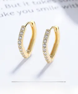 Macro detail of gold plated S925 sterling silver square earrings with clear zircon stones