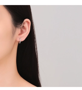 Close-up of small silver geometric square hoop earrings with micro-pave white zircons