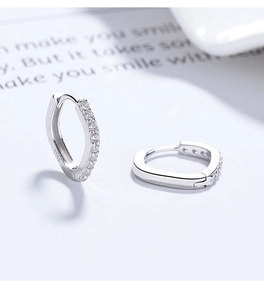 Detail of S925 sterling silver hoop earrings with white zircon stones and engraved hallmark