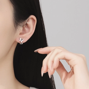 Polished S925 sterling silver double butterfly hoop earrings on female model