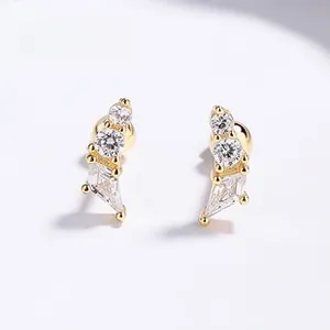 Macro shot of gold butterfly stud earrings featuring brilliant white zircon claw setting