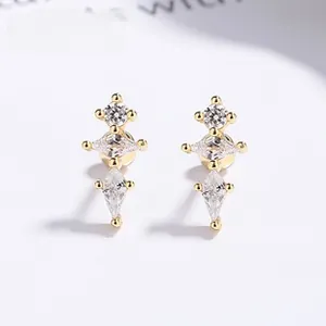 Detail of S925 silver gold studs featuring triple-tier clear zircon stones in claw settings