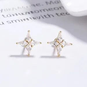 Macro view of gold North Star stud earrings featuring sparkling clear zirconia stones