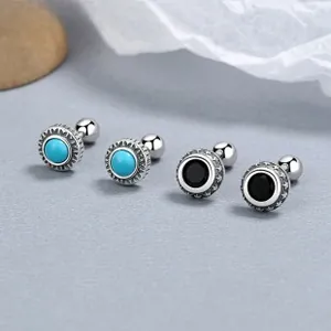 Macro shot of 925 silver turquoise stud earrings with detailed star patterns and screw backs