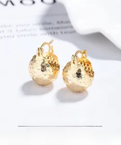 Macro view showing the S925 hallmark on gold plated textured ball stud earrings