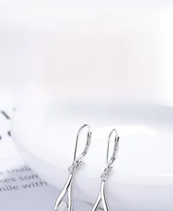 Macro shot of S925 sterling silver drop earrings with clear teardrop zircon stones