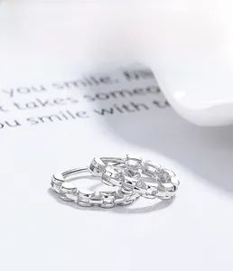 Macro shot of S925 sterling silver hoop earrings with modern geometric link pattern