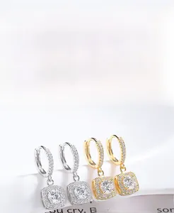 Macro detail of S925 sterling silver square zircon hoop earrings in gold and silver
