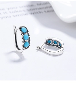 Detail view of S925 sterling silver hoop earrings with three turquoise stones in retro style