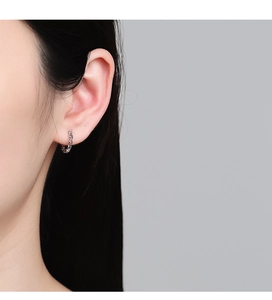 Close-up of minimalist S925 sterling silver chain link hoop earrings on ear