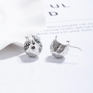 Sparkling S925 sterling silver laser ball earrings with textured pine cone design