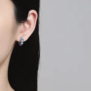Vintage S925 sterling silver hoop earrings with three turquoise stones on female model