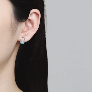 S925 silver irregular stud earring with turquoise bead shown on a female model
