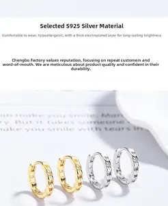 Detailed view of silver and gold chain-link hoop earrings made of S925 sterling silver