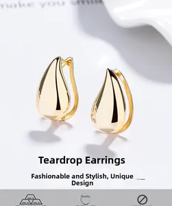 Detailed view of gold-plated teardrop earrings with a smooth polished mirror finish