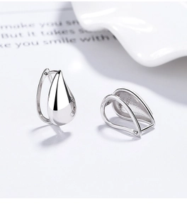 Macro shot of S925 sterling silver teardrop earrings showing the S925 hallmark stamp