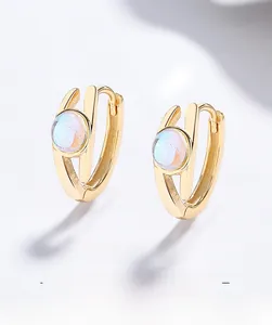 Détail de boucles d'oreilles en argent 925 doré en U avec pierres turquoise rondes