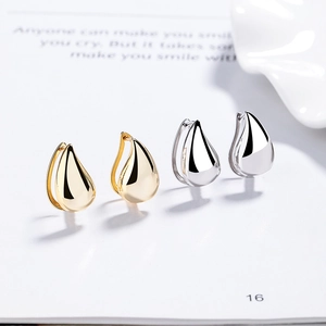 Polished 925 sterling silver and gold teardrop hoop earrings for women in a minimalist style