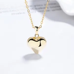 Macro shot of 925 silver heart pendant in gold finish with mirror polished surface